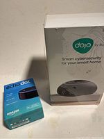 Photo showing Amazon Echo Dot box and BullGuard Dojo box side-by-side.