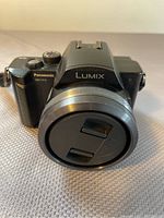 Front view of Panasonic Lumix DMC-FZ10 camera with lens cap on and showing brand Lumix.