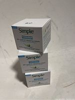 Three stacked boxes of Simple Skin Quench Sleeping Cream, each 1.7 oz in size, shown from the front and side angles.