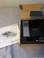 Vizio Co-Star KT media player and remote in original packaging with quick start guide.