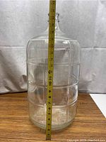 Full front view showing jug height approximately 19 inches measured by tape measure.