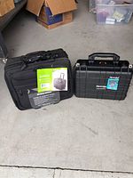 Photo showing both the Samsonite Mobile Office laptop suitcase and the black Apache 3800 protective hard case side by side on a concrete floor.