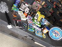 Overview showing multiple personal care and household items including soaps, deodorants, combs, alertness aids, clock