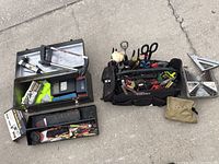 Overview of the tool lot showing three main components: two metal toolboxes and one soft tool bag filled with various tools and accessories.