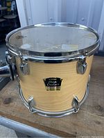 Yamaha 12-inch tom drum with natural wood finish and chrome hardware, showing overall condition.