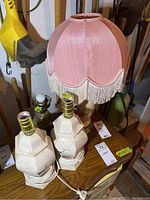 Two matching 13-inch ceramic lamps with hexagonal textured bases and cords coiled at bottom, no shades.