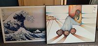 Two prints side by side: the Japanese Hokusai plaque on the left and the southwestern themed framed print on the right.