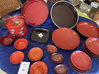 Top view of entire lacquerware set showing bowls, trays, and small dishes spread on table