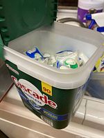 Open container of Cascade dishwasher pods showing individual pods inside.