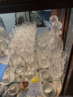 Shelved arrangement: decanter, 6 champagne flutes, 3 wine glasses and 4 rocks glasses