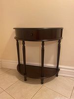 Front view of the half circle wooden hallway table showing the drawer and lower shelf