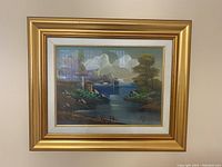 Framed oil painting showing the entire framed artwork with a gold frame and white matting, highlighting the coastal landscape scene.