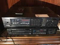 Front view of stacked Onkyo TX80 tuner amplifier on top, Kenwood DP750 CD player below with remote on top of amplifier.