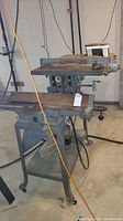 Full view of the Delta table saw showing the construction, base with wheels, and working surface.