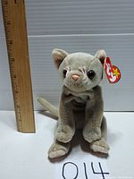 Front profile of the plush Ty Beanie Baby Scat kitten cat with a wooden ruler showing height approximately 8 inches.