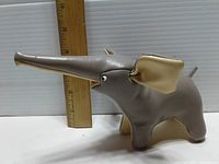 Side view of vintage vinyl and leather elephant child’s toy with ruler for size reference showing length approximately 16 inches.