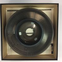 Top down image of one Kodak Carousel 140 slide projector reel filled with slides in a box with Kodak branding.