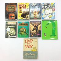 Top-down view of all nine books showing front covers in a grid layout.