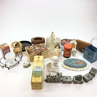 Full view of the assortment showing pewter train, sewing kit, figurines, conch shell, candle holder, decorative trays, and other small decorative items.