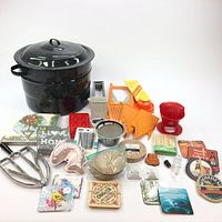 Full view of the lot showing canning pot, slicer, kitchen utensils, coasters, and decorative items arranged on a white background.