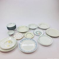 Full view of assorted plates and bowls showing variety of patterns and sizes.