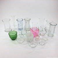 Collection of 19 assorted glass vases with varying shapes and sizes including clear, green, pink, and frosted glass varieties.