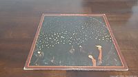 Front cover of the vinyl LP album showing a starry night scene with band members' silhouettes.