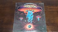 Front cover of the album 'Boston' featuring spaceship artwork and band logo.