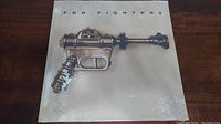 Front cover featuring a vintage sci-fi ray gun illustration labeled 'Foo Fighters'