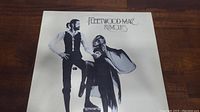 Front cover of Fleetwood Mac's Rumours album with stylized black and white illustration.