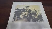 Front cover of Neil Young Comes A Time album showing Neil playing guitar.