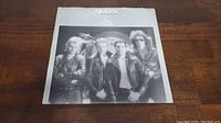 Front cover of Queen's 'The Game' album featuring the band members in black leather jackets.
