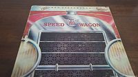 Front cover of R.E.O. Speedwagon vinyl album showing distinctive car grille design with band name and logo.