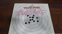 Front of sleeve with Trooper Hot Shots logo and target design.