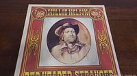 Front cover of the Willie Nelson Red Headed Stranger vinyl record album featuring a portrait of Willie Nelson.