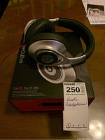 Beats Executive over-ear headphones resting on the original box with a label showing lot number and brief handwritten note.
