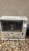 Full view of the front of the heater, showing the metal grill and outer casing with control panel below.