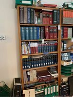 Wooden shelves filled with various legal reference books and binders