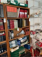 Wood bookshelf with assorted law books and binders