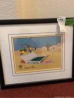 Full view of framed production cel featuring Wile E. Coyote in cactus costume with double mat and black frame