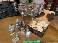 Overview of candelabras, roosters, shakers, napkin rings, basket and glass apples