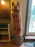 Full front view of the carved pine bear sculpture showing overall shape and dimensions.