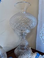 Full side view of lamp showing entire faceted base, midsection, and globe