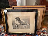 Two framed wall art pieces, black decorative frame in front and gold frame behind
