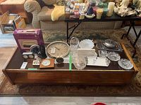 Top view of the wood coffee table with glass top displaying various items (not included in sale).