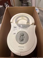 Top view of Honeywell Quiet Care humidifier inside its original cardboard box showing the entire unit and control panel.