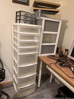 View of three Gracious Living plastic storage containers with multiple white frames and clear drawers.