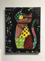 Front view of a colorful oil painting depicting a cat in patchwork style with various colors and patterns on black background.
