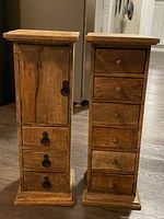 Pair of solid wood jewelry standing units, front view showing door and drawers.