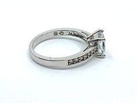 Side view showing princess cut crystal and pave detail along the rhodium plated band.